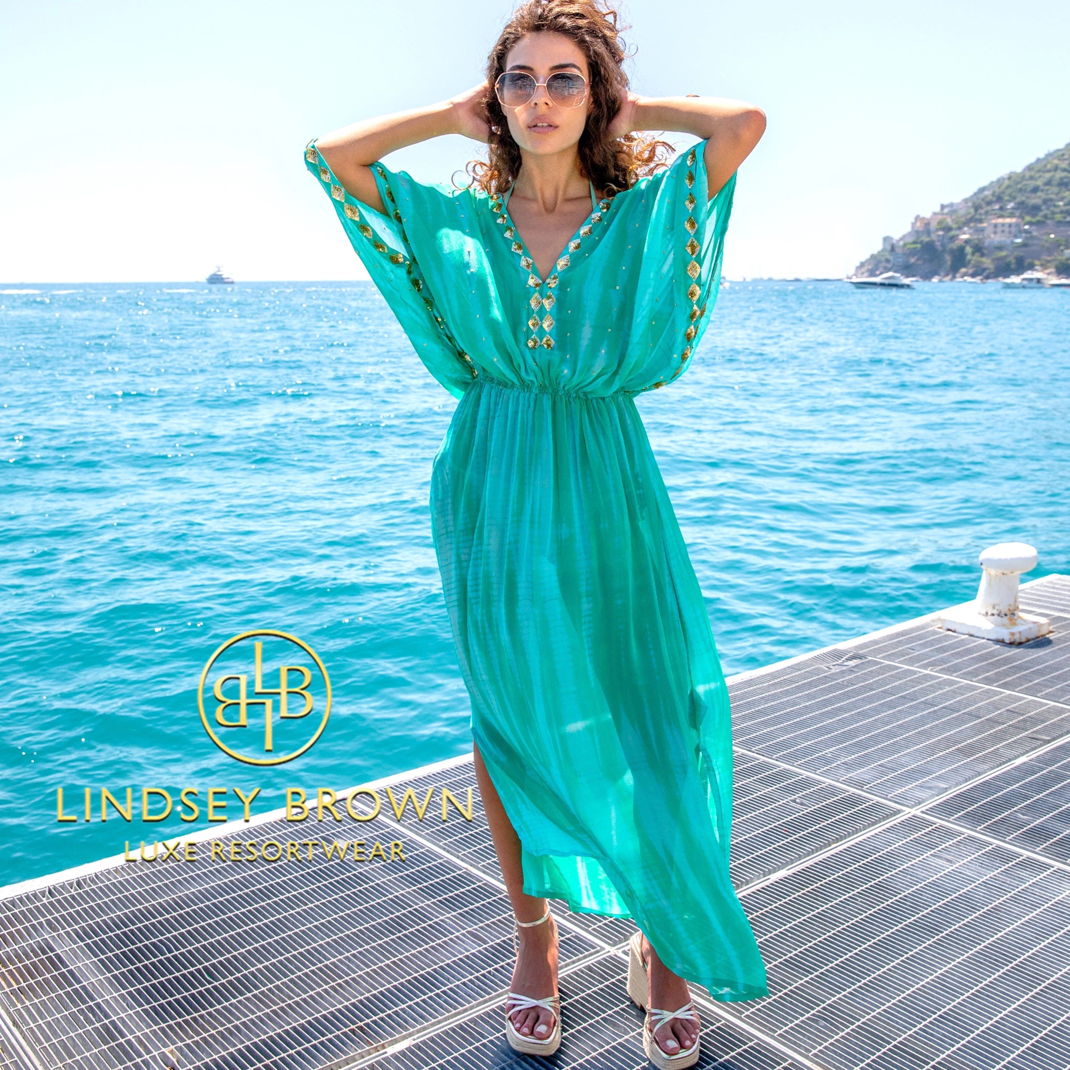 Aqua silk maxi kaftans to wear on holiday by Lindsey Brown silk luxury resort wear.