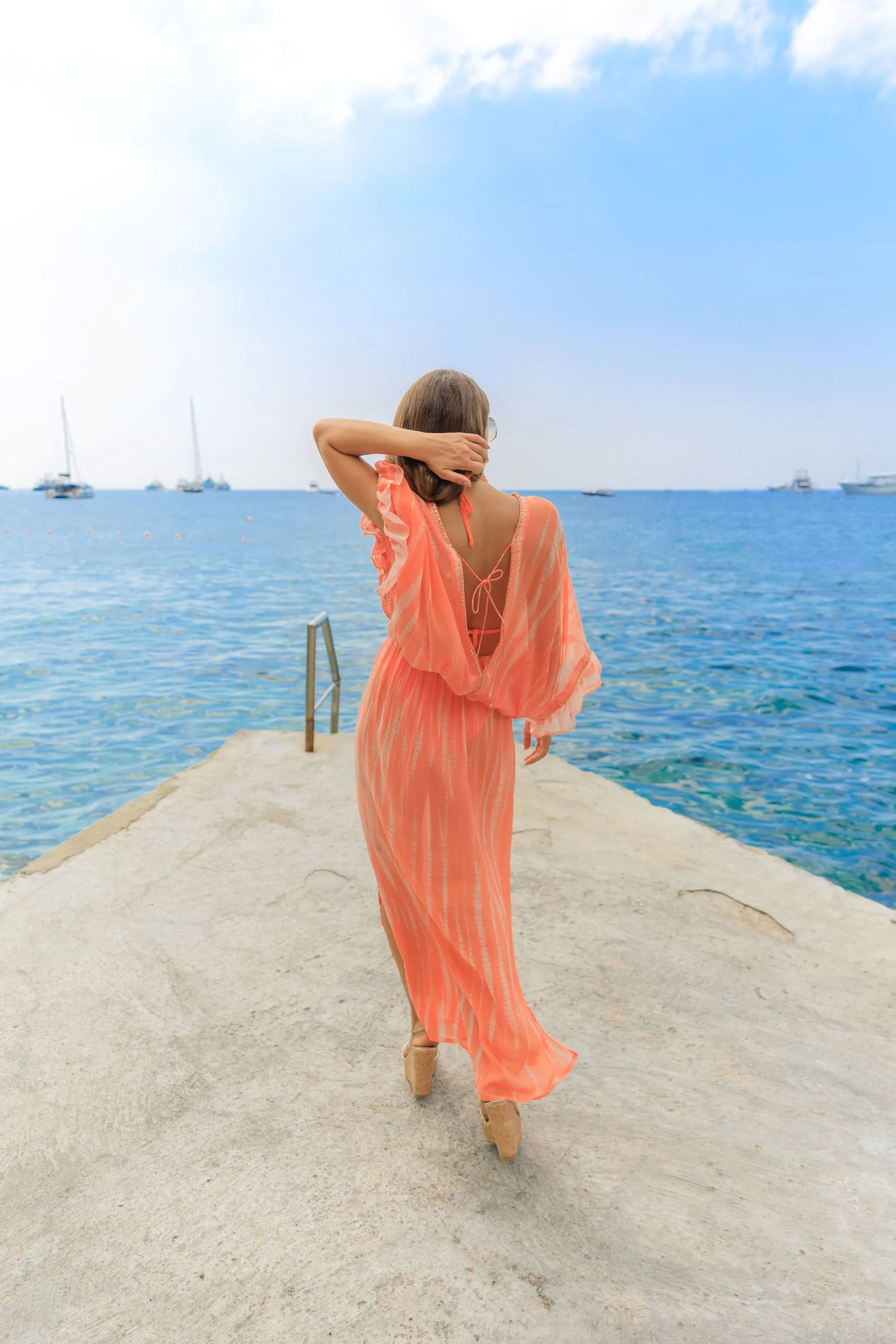 orange silk maxi kaftans to wear on vacation by Lindsey Brown luxury silk resort wear
