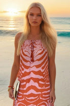 orange and pink tiger printed sleeveless maxi dresses to wear on vacation by Lindsey Brown