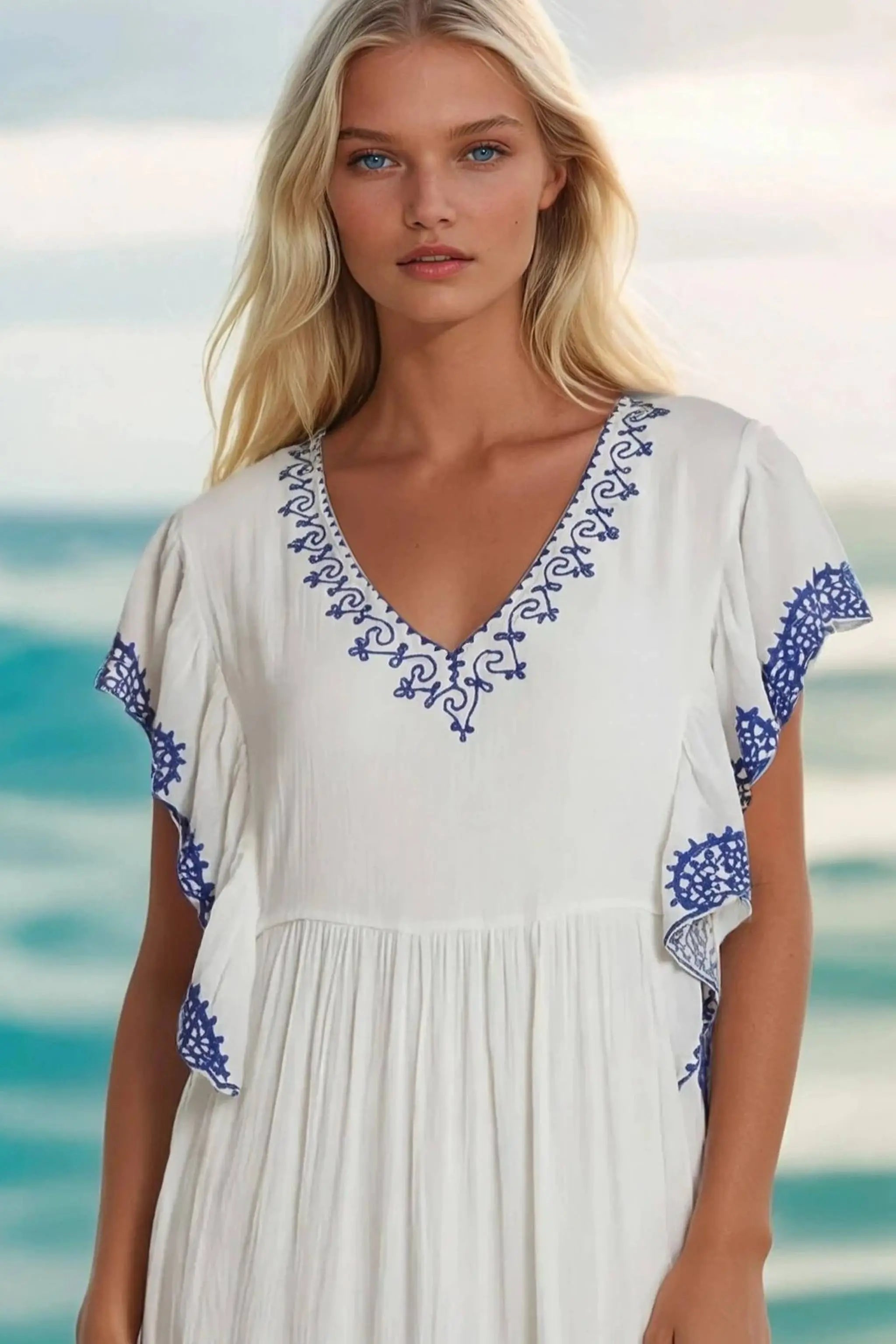 White cotton midi dresses with blue embroidery by Lindsey Brown