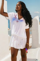white plus size  bloused short beach dress to wear on holiday by Lindsey Brown luxury resort wear 